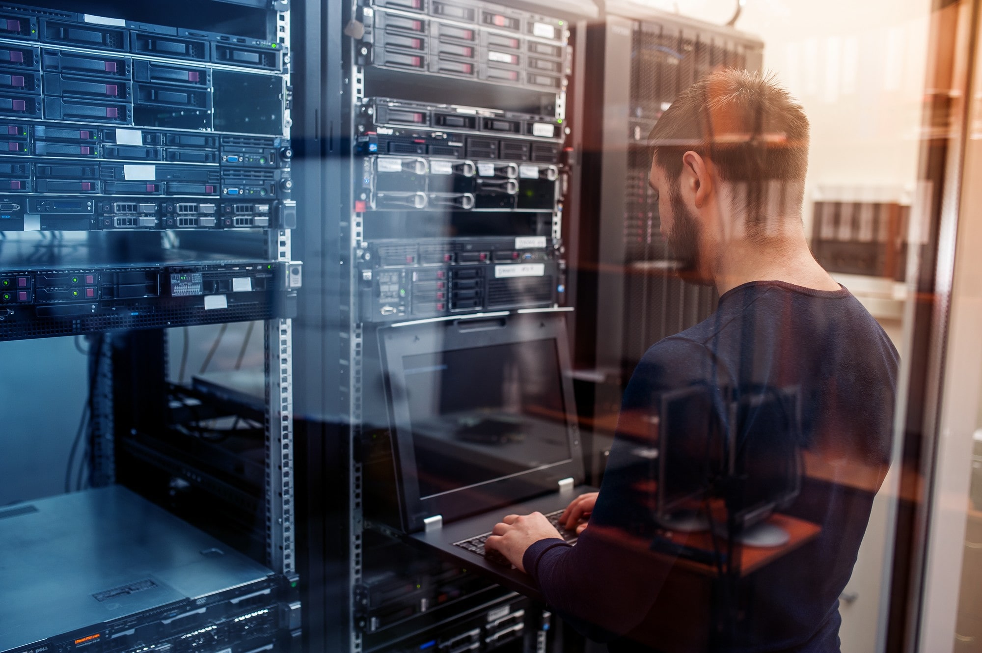 Man Using a Computer in Server Room
