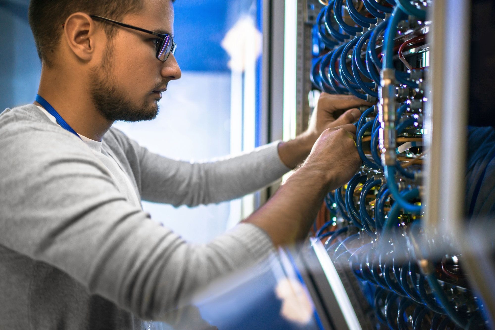 Man Plugging in Network Cables